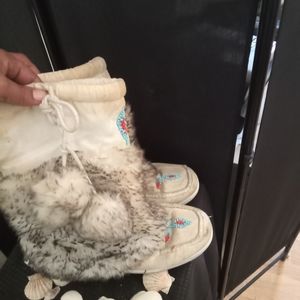 Moccasin mid calf pom pom boots